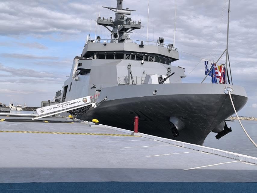 An offshore patrol vessel moored at port during commissioning ceremony